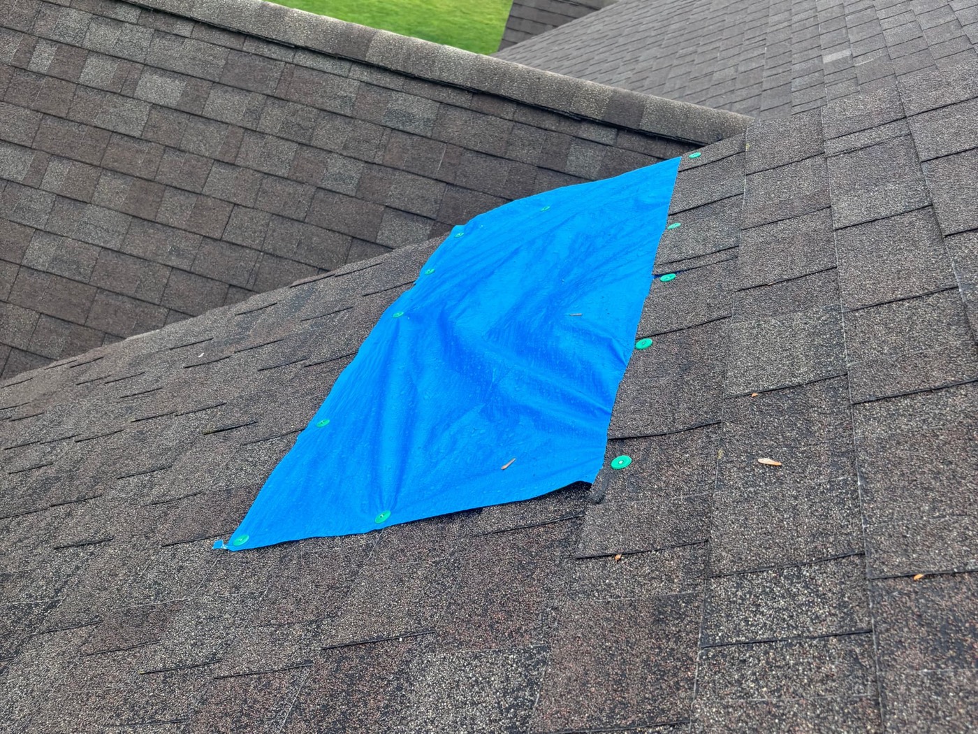 Emergency tarp installed on a storm-damaged roof