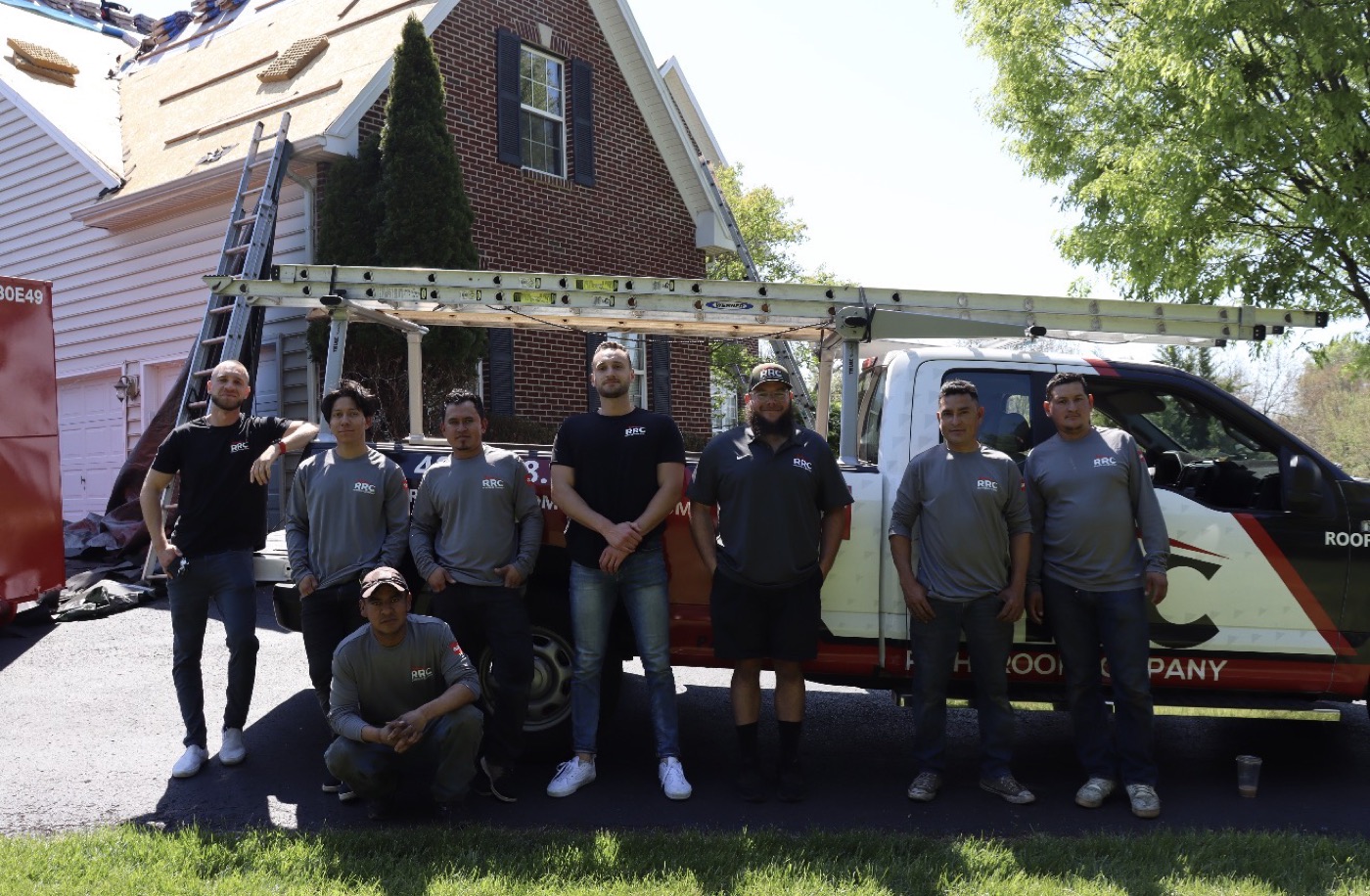 The RightRoof Company crew in front of a branded truck at a job site