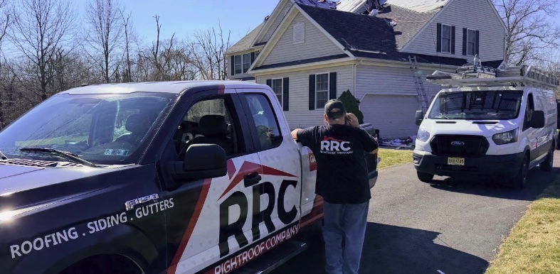 The RightRoof crew on site with company trucks